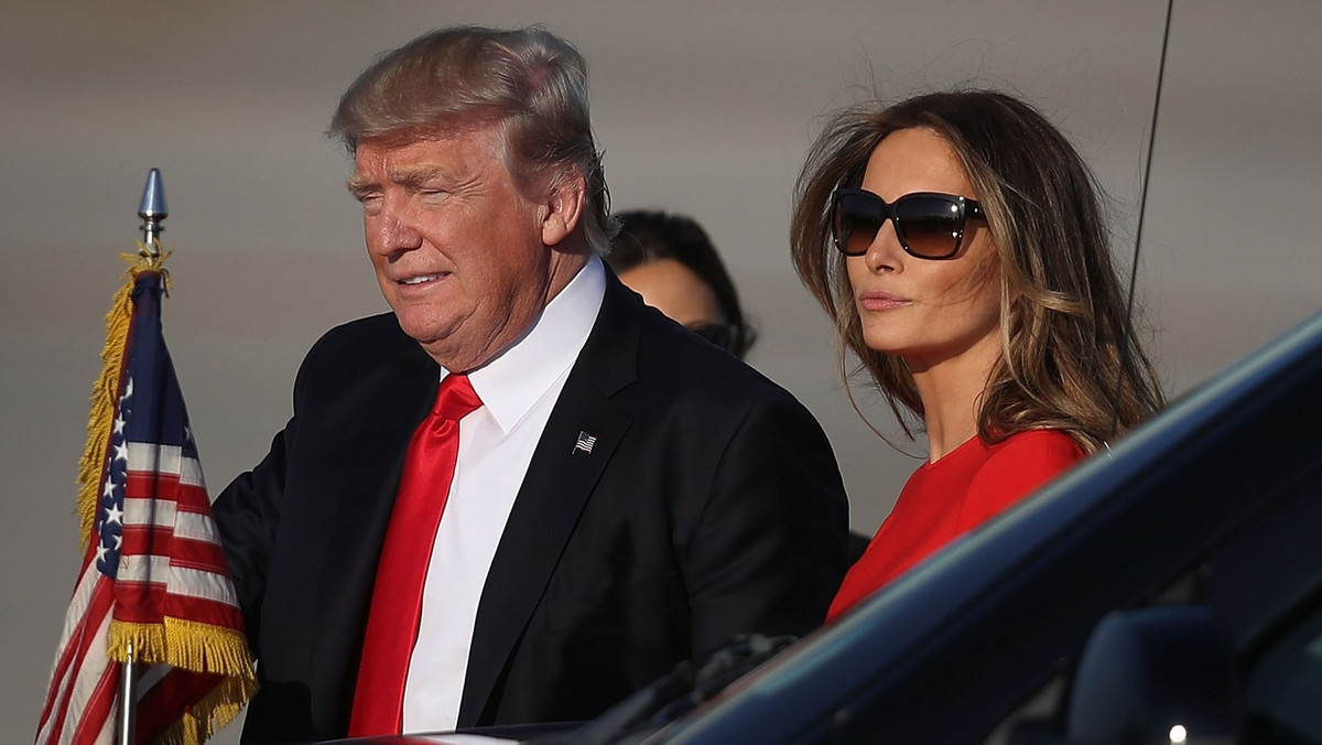  President Donald Trump walks with his wife Melania Trump PALM BEACH, FL - FEBRUARY 03: U.S.