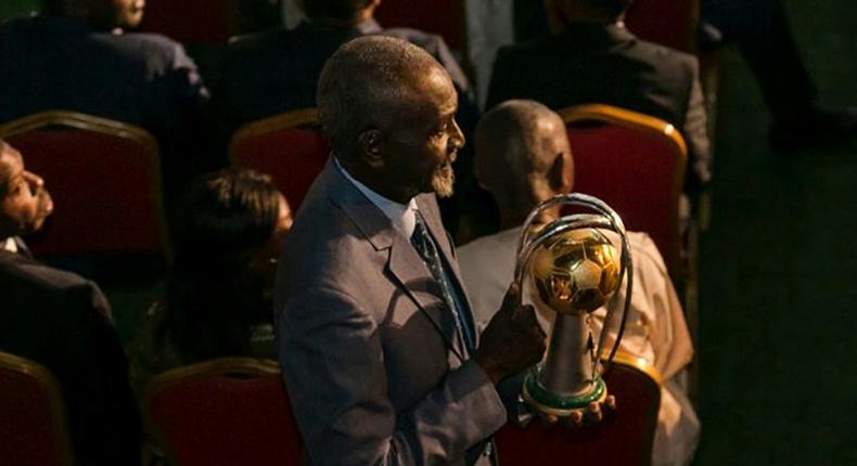 Stephen Tataw carries the trophy of the African Championship of Nations (CHAN) to the stage during the draw ceremony in Yaounde in February