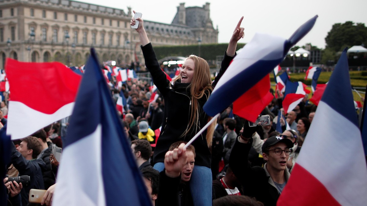 Supporters of Emmanuel Macron celebrate near the Louvre museum after results were announced in the second round vote of the 2017 French presidential elections, in Paris