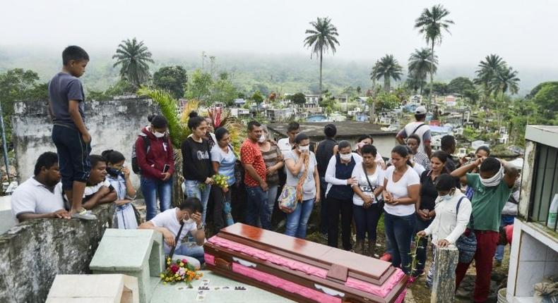 Relatives and friends of Deisy Rosero, 26, pray during her funeral at a cemetery in Mocoa, Putumayo department, southern Colombia on April 3, 2017