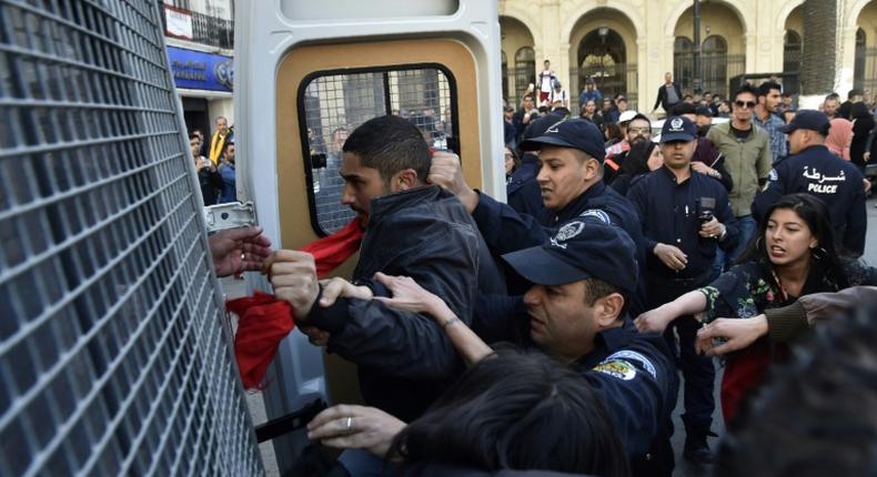 Algerian police detain protesters after a demonstration in the capital Algiers on April 14, 2019