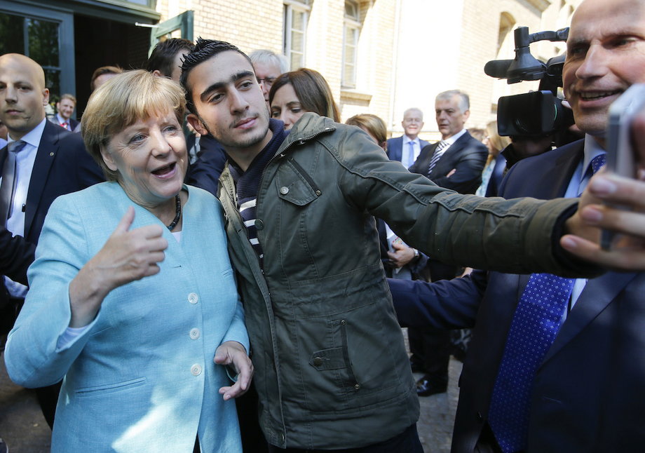 Syrian refugee Anas Modamani takes a selfie with German Chancellor Angela Merkel outside a refugee camp near the Federal Office for Migration and Refugees after registration at Berlin's Spandau district, Germany September 10, 2015.