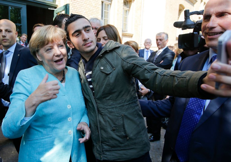 Syrian refugee Anas Modamani takes a selfie with German Chancellor Angela Merkel outside a refugee camp near the Federal Office for Migration and Refugees after registration at Berlin's Spandau district, Germany September 10, 2015.