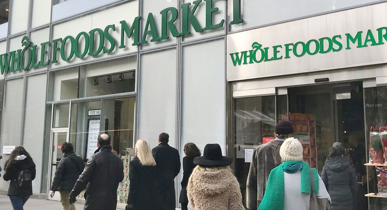 Shoppers outside of a Whole Foods Market.