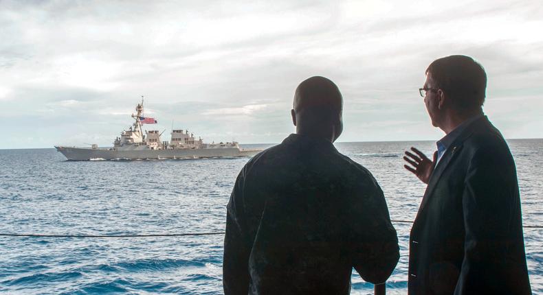 US Secretary of Defense Ash Carter, right, speaks with Navy Cmdr. Robert Francis Jr.