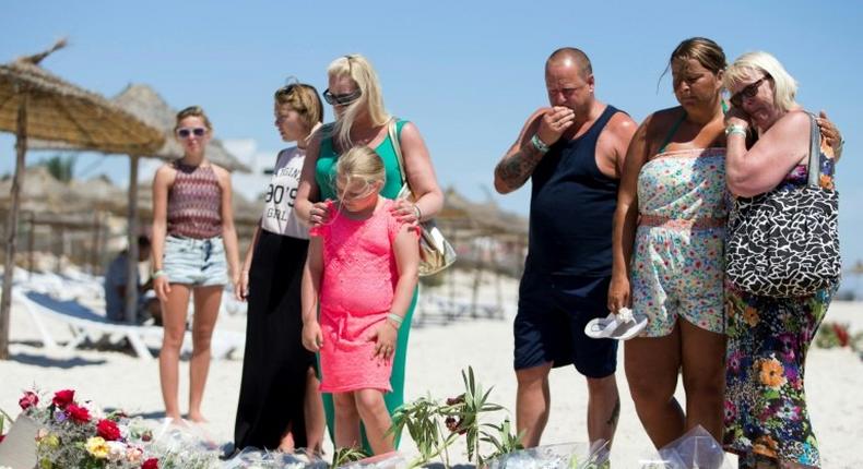 A British family, who witnessed the beach massacre by a jihadist gunman in Tunisia, lay flowers at the site of the attack on the outskirts of Sousse on June 30, 2015