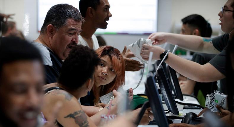 People buy products at the Essence Vegas Cannabis Dispensary on July 1. Nevada dispensaries were legally allowed to sell recreational marijuana starting at 12:01 a.m. that day.