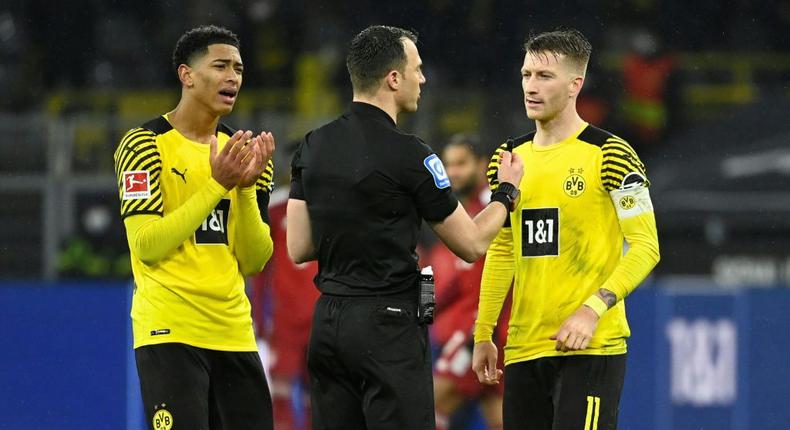 Dortmund's Jude Bellingham (L) and Marco Reus (R) argue with referee Felix Zwayer during their Bundesliga defeat to Bayern Munich in December Creator: Ina FASSBENDER