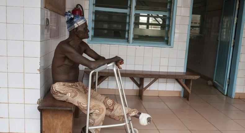 A man who lost his left foot to leprosy, waits for treatment at the Raoul Follereau Foundation facility in Pobe