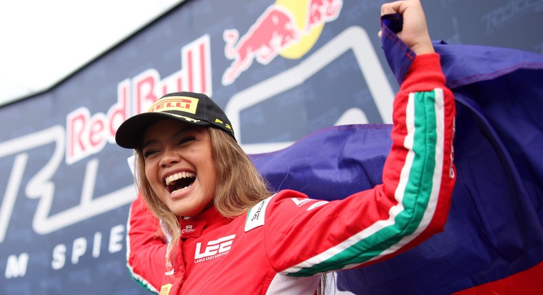 Bianca Bustamante celebrates on the podium, holding the Philippines flag, at the F1 Academy Series in May 2023.Adam Pretty - Formula 1/Formula 1 via Getty Images