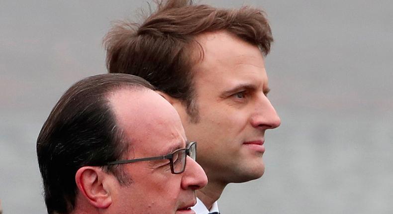 Outgoing French President Francois Hollande (L) and President-elect Emmanuel Macron attend a ceremony to mark the end of World War II at the Tomb of the Unknown Soldier at the Arc de Triomphe in Paris, France, May 8, 2017.