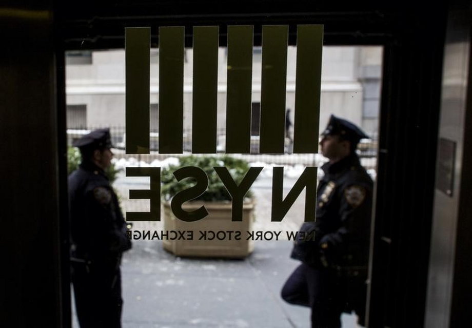 New York City Police officers (NYPD) stand outside a door to the New York Stock Exchange in New York's financial district