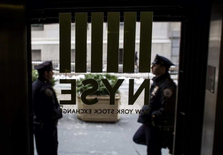 New York City Police officers (NYPD) stand outside a door to the New York Stock Exchange in New York's financial district