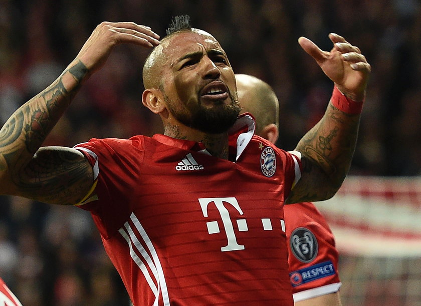 Bayern Munich's Arturo Vidal looks dejected after being sent off as Real Madrid's Sergio Ramos looks