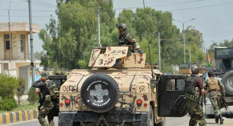 Afghan soldiers arrive during an attack on a prison in Jalalabad. At least 29 people have been killed in fighting at the jail, which houses 1,700 Islamic State and Taliban inmates