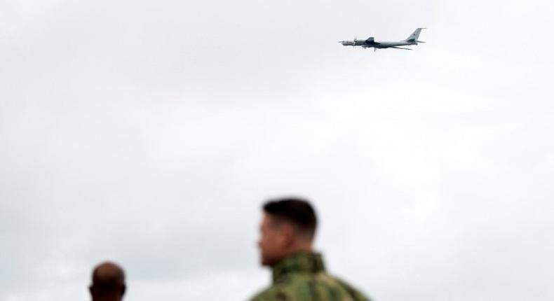 NATO forces on the USS Moutn Whitnes watch a Russian Tupolev TU-142 fly past