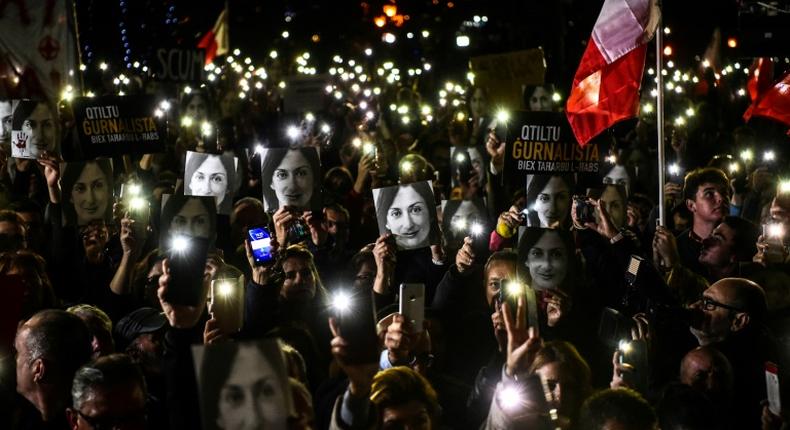 Maltese journalist Daphne Caruana Galizia, seen here protesters' photos, was killed by a carbomb in 2017