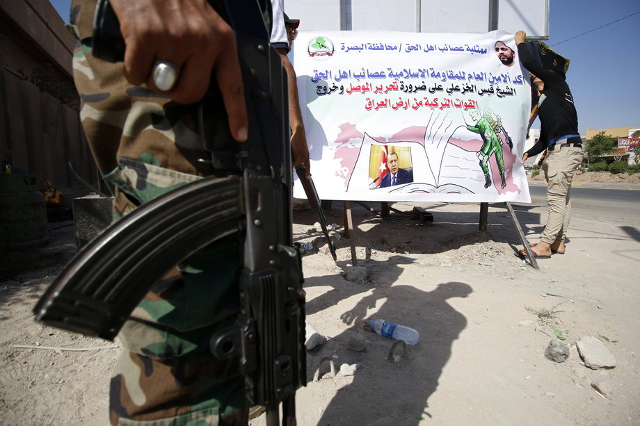 Members of Shi'ite group Asaib Ahl al-Haq put banners in the street against Turkey's military presence in Iraq, in Basra, southeast of Baghdad, October 13, 2016