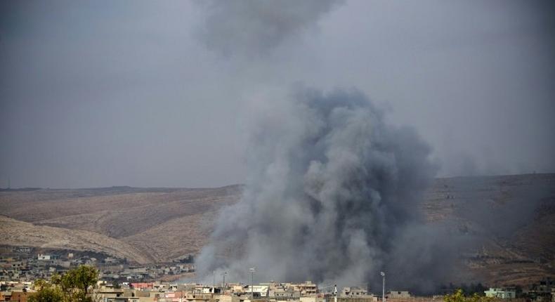 Smoke and dust billow following an air strike in Bashiqa on November 8, 2016, as the Iraqi Kurdish forces pushed deeper into the town during street battles against Islamic State group jihadists