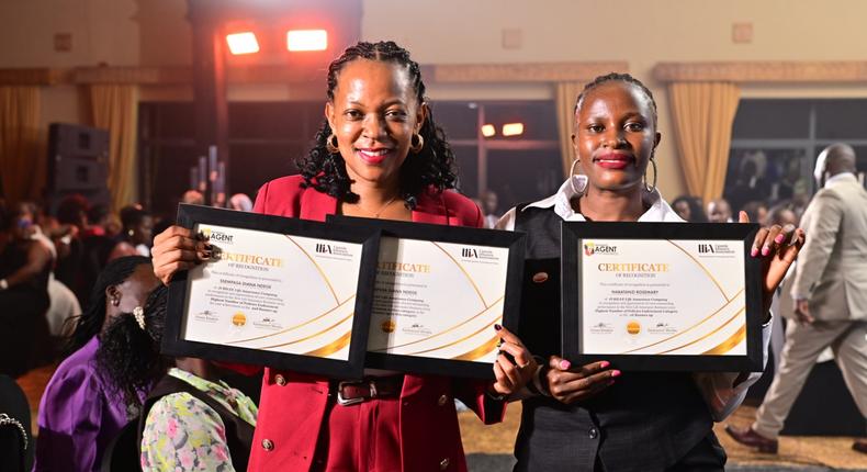 Jubilee's Diana Ssempasa Ndege (L) and  Nabatanzi Rosemary display their certificates