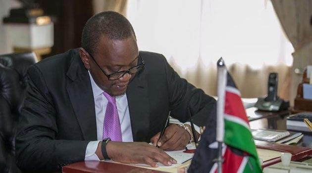 President Uhuru Kenyatta signing a bill 