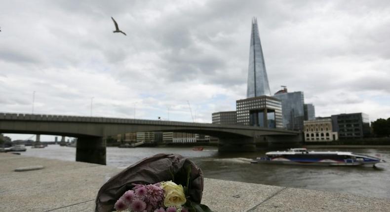 A single bunch of flowers lies on a wall on the northern bank of the River Thames close to London Bridge on June 4, 2017