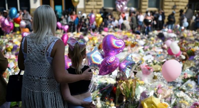 People gather in St Ann's Square in Manchester, northwest England