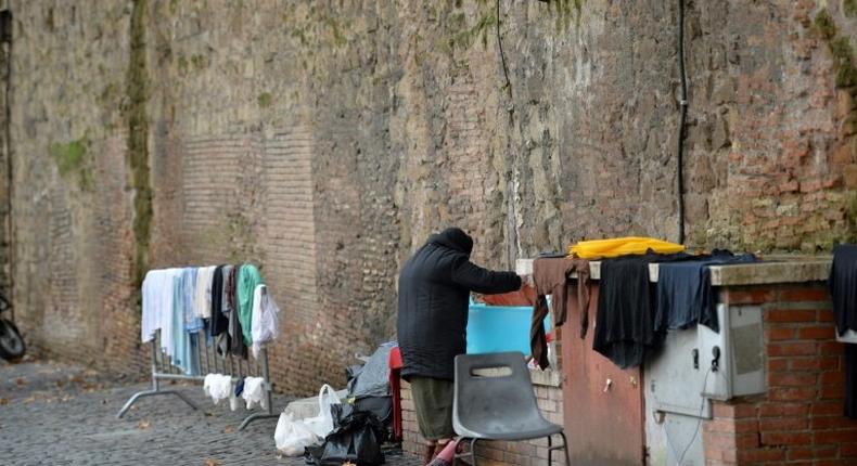 A homeless women does her laundry where she lives near the Vatican, which announced the opening of a free launderette for the poor and homeless