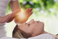 Woman having reiki healing treatment , alternative medicine concept.