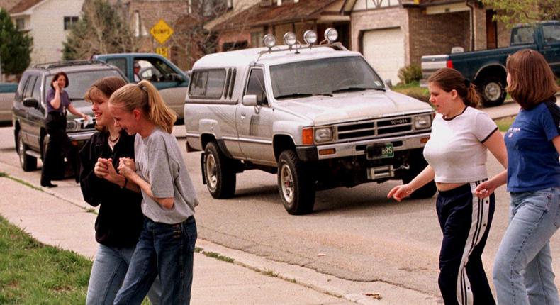 Students from Columbine High School are led away from the facility after two gunmen went on a shooting rampage Tuesday, April 20, 1999, in the southwest Denver suburb of Littleton, Colo. (