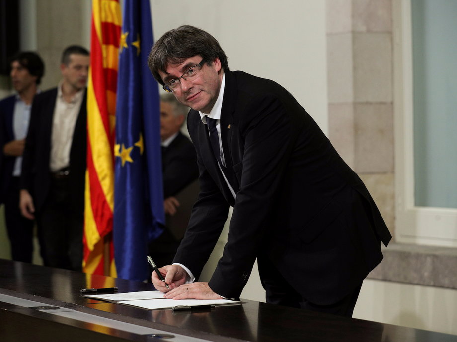 Catalan President Carles Puigdemont signing a "symbolic" declaration of independence in Barcelona, Spain.