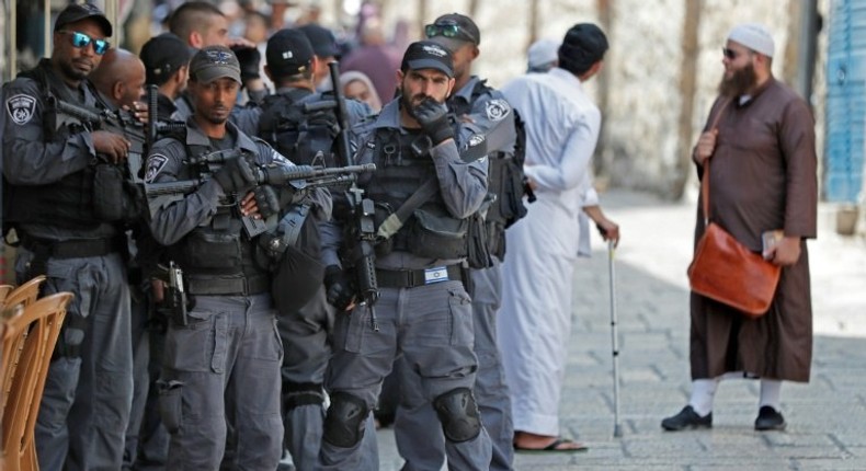 Israeli security forces stand by as Palestinian worshippers gather to pray in the old city of Jerusalem on July 26, 2017