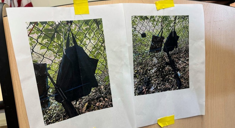 Photos that show an AK-47 rifle, a backpack and a Go-Pro camera on a fence outside Trump International Golf Club taken after an apparent assassination attempt of Republican presidential candidate former President Donald Trump, are displayed during a news conference at the Palm Beach County Main Library.Stephany Matat