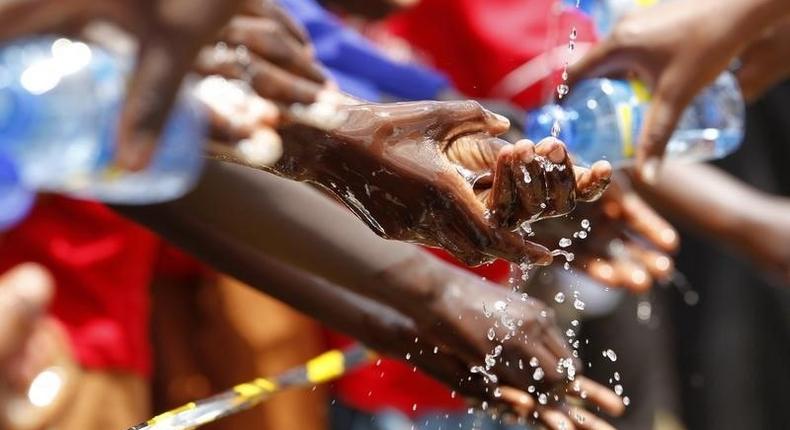 School children wash their hands during an activity to mark the third annual Global Handwashing Day at Thirime primary school in Kikuyu, near Kenya's capital Nairobi, October 15, 2010.  REUTERS/Thomas Mukoya