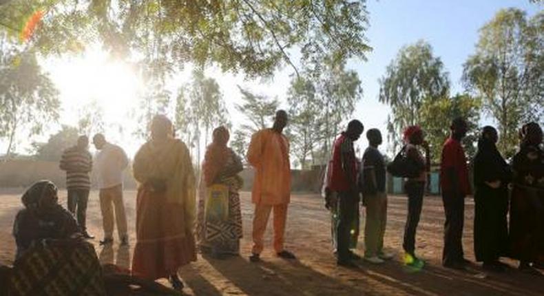 People queue to vote during the presidential and legislative election at a polling station in Ouagadougou, Burkina Faso, November 29, 2015.