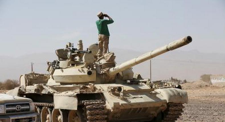 A soldier loyal to Yemens President Abd-Rabbu Mansour Hadi stands atop a tank as he uses binoculars in Majaz district, in the countrys northwestern provinceo of Marib, after the pro-Hadi forces took the area from Houthi rebels, December 18, 2015.
