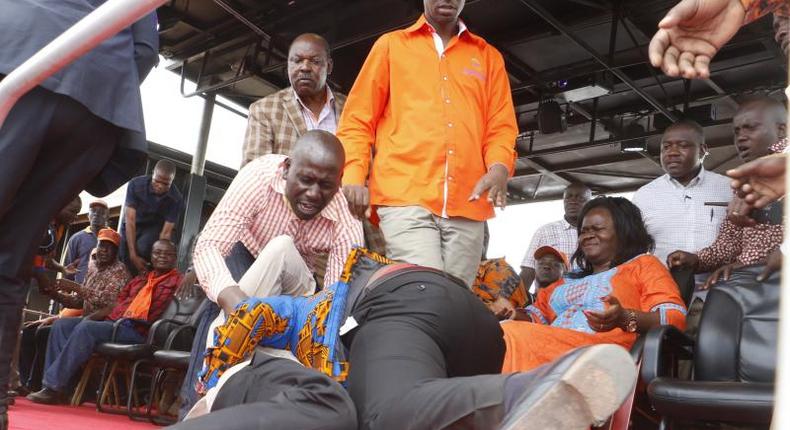 Homa Bay Town MP Peter Kaluma and his rival Washington Ogaga wrestle each other to the ground before ODM supporters and party leaders at the Homa Bay Stadium on November 27, 2016.