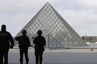 French police secure the site near the Louvre Pyramid in Paris