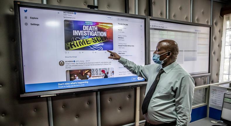 A police officer in charge of the call center scrolls through the directorate’s Twitter feed on a large screen.