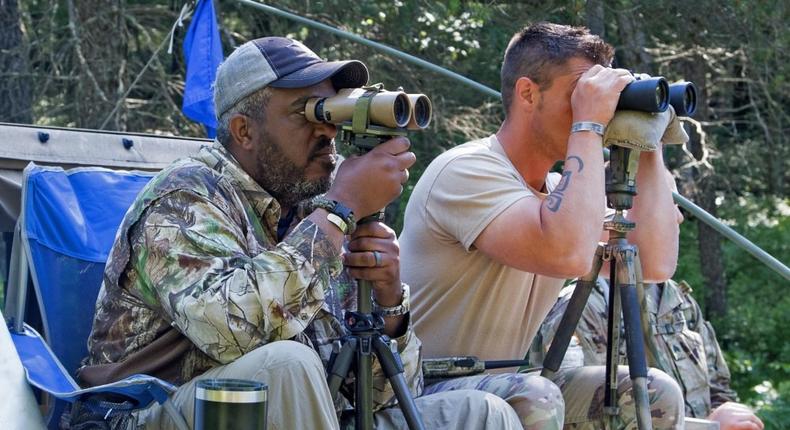 Tarrol Peterson, a US Army Sniper Association instructor and former instructor at the US Army's Sniper School at Fort Benning, Georgia, and Bastian look for snipers during the stalking portion of the 10-day sniper training course.