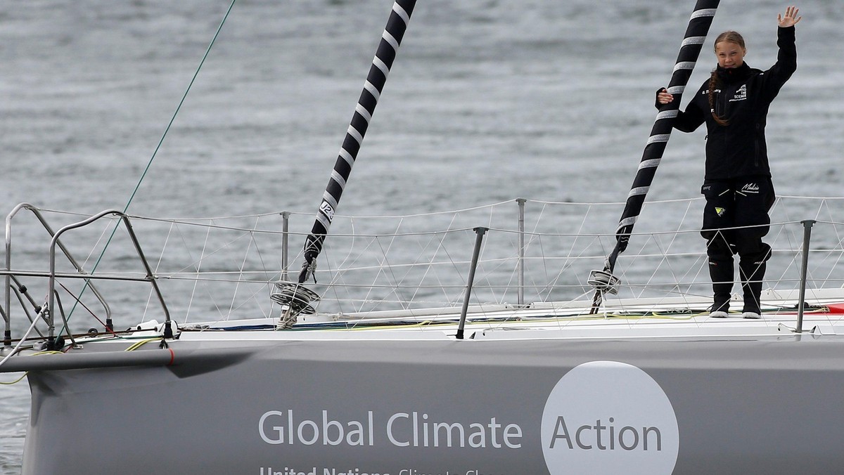 Swedish teenage climate activist Greta Thunberg waves from a yacht as she starts her trans-Atlantic boat trip to New York, in Plymouth