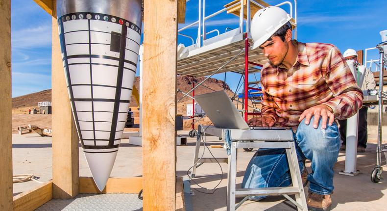 A Sandia National Laboratories engineer performs a final diagnostics check on a data recorder for an impact test on the nose assembly of a mock B61-12.