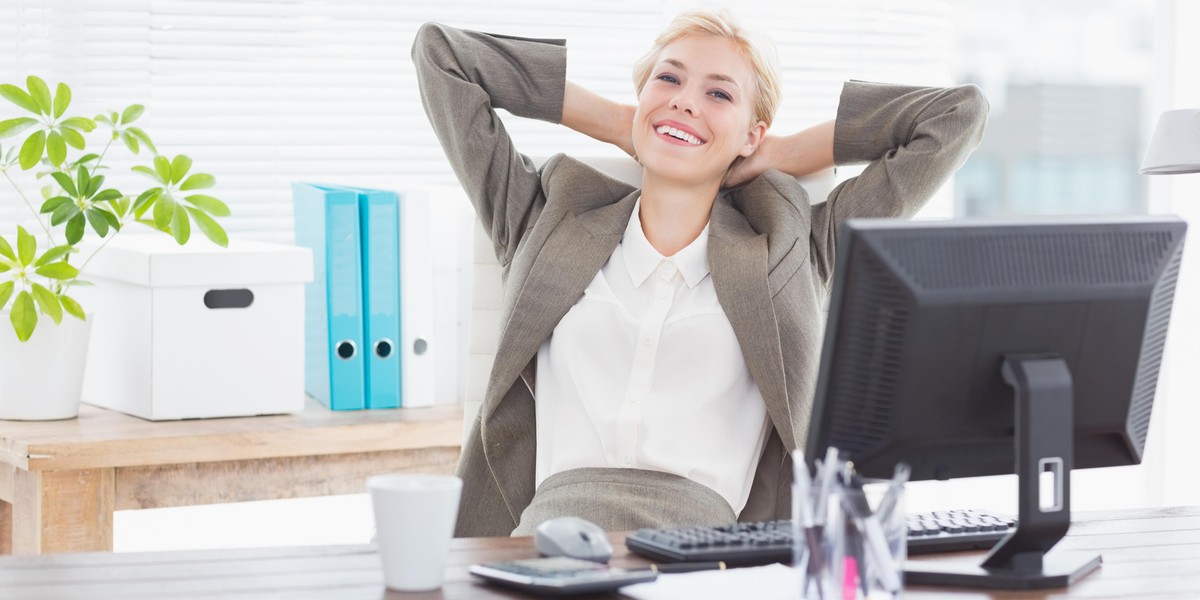 Smiling businesswoman looking at camera in her office