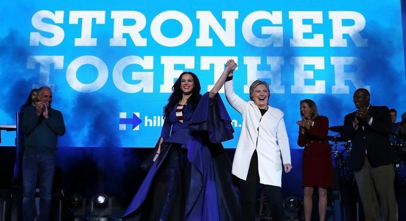 Hillary Clinton raises her arms with recording artist Katy Perry (L) during a get-out-the-vote concert at the Mann Center for the Performing Arts on November 5, 2016 in Philadelphia, Pennsylvania