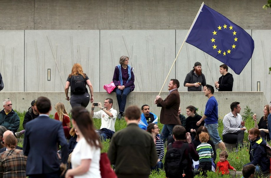 A man waves a European Union flag outside the Scottish Parliament at Holyrood in Edinburgh.