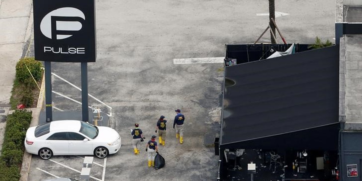 FBI officials walk through the Pulse nightclub parking lot in Orlando.