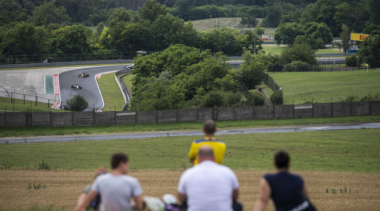 Szurkolók figyelik a Forma-1-es autós gyorsasági világbajnokság Magyar Nagydíjának futamát Mogyoródon, a Hungaroring melletti dombról 2020. július 19-én. A versenyt a koronavírus-járvány miatt zárt kapuk mögött tartják. / Fotó: MTI/Mónus Márton