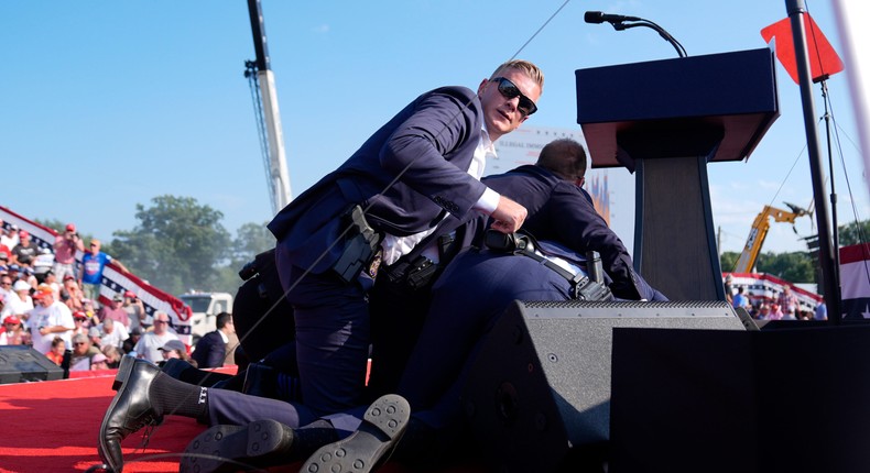 The US Secret Service shielding former President Donald Trump onstage at a Pennsylvania rally.Evan Vucci via AP