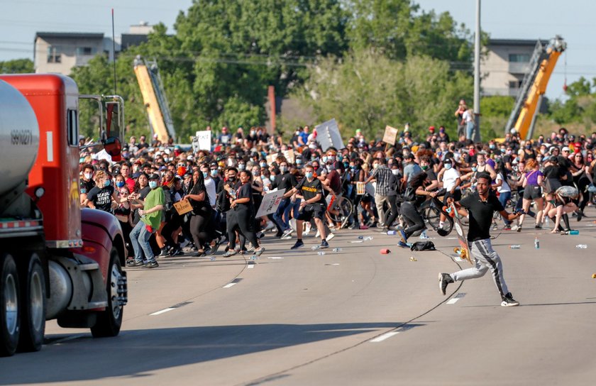 Protesters scale a truck that was driven into a rally