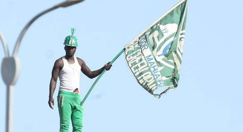 K'Ogalo fan waving the Gor Mahia F.C. flag during match day in May 2023 [Image Credit: Gor Mahia FC on X]